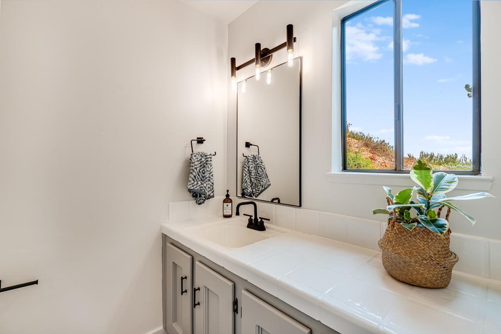 390 Brooktree Ranch Road Aptos, CA 95003 - Photo 19 of 33 a bathroom with a sink a vanity and a mirror