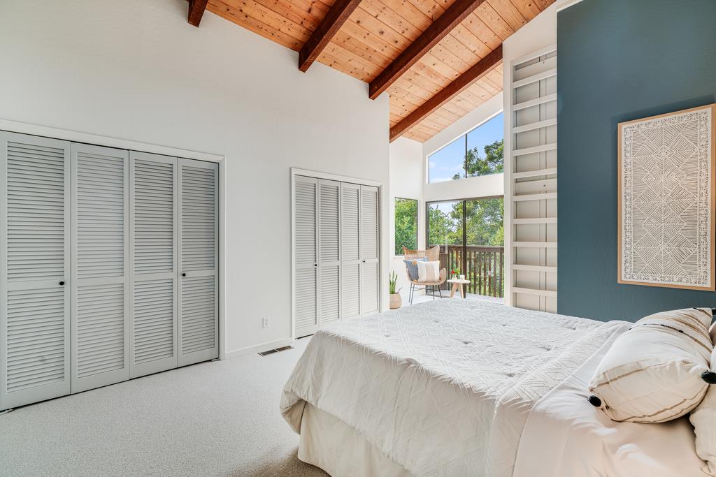 390 Brooktree Ranch Road Aptos, CA 95003 - Photo 22 of 33 a bedroom with a bed and a large window