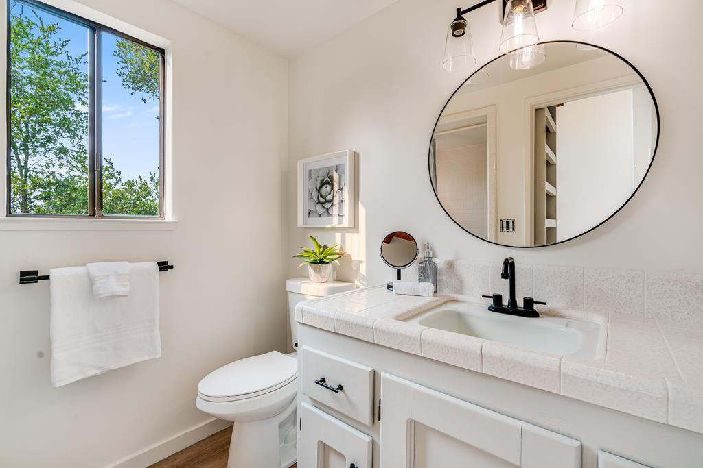 390 Brooktree Ranch Road Aptos, CA 95003 - Photo 24 of 33 a bathroom with a sink a mirror and a toilet