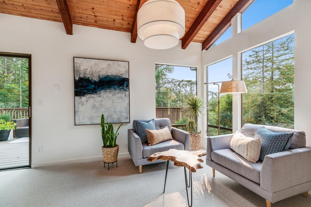 390 Brooktree Ranch Road Aptos, CA 95003 - Photo 8 of 33 a living room with furniture a flat screen tv and a floor to ceiling window