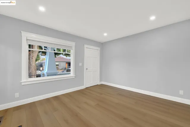 a view of a room with wooden floor and window