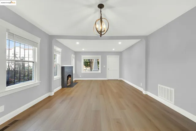 a view of wooden floor and windows in a room