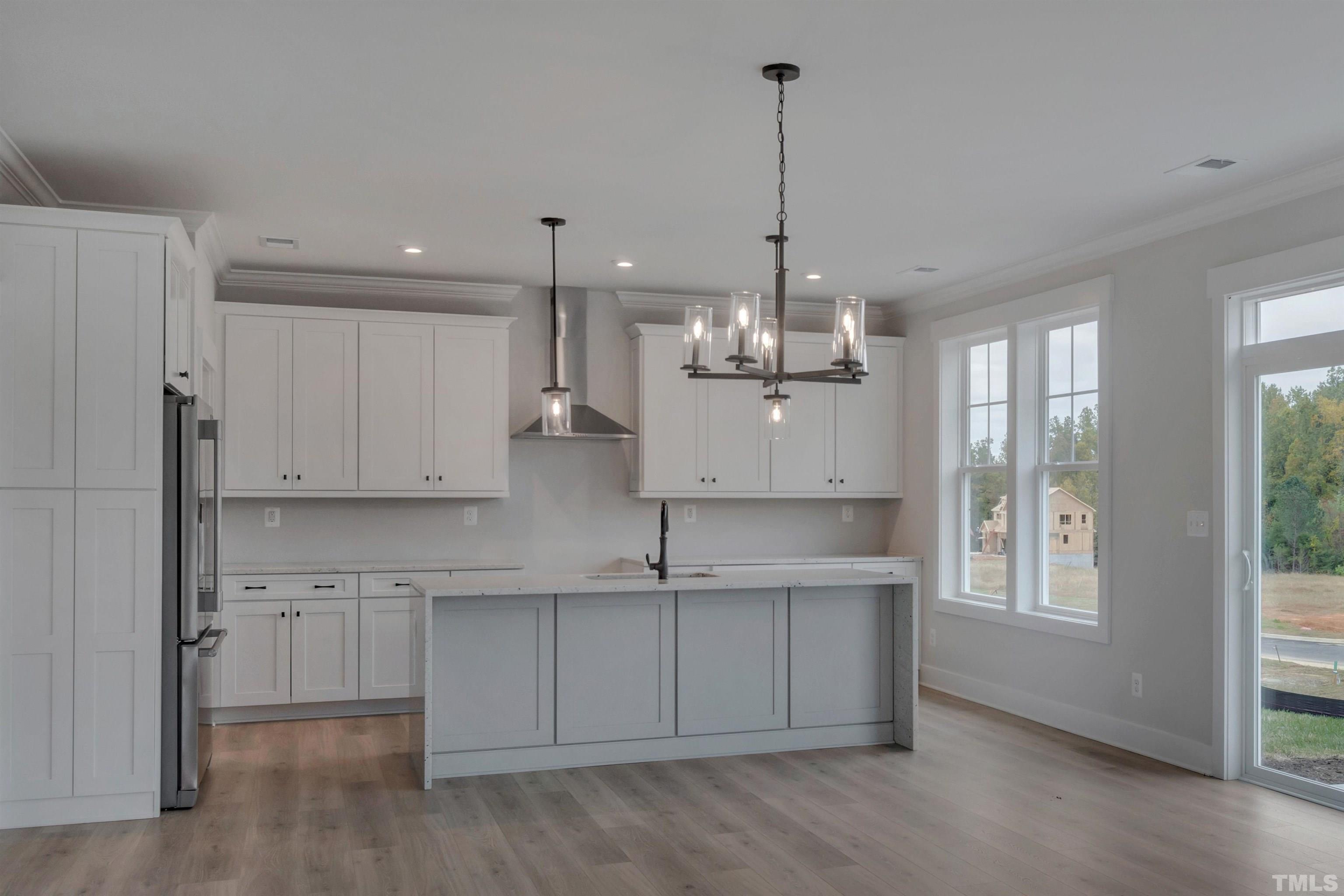 167 Dunloe Loop Raleigh, NC 27603 - Photo 4 of 16 a view of a kitchen with stainless steel appliances granite countertop a sink a refrigerator and a granite counter tops