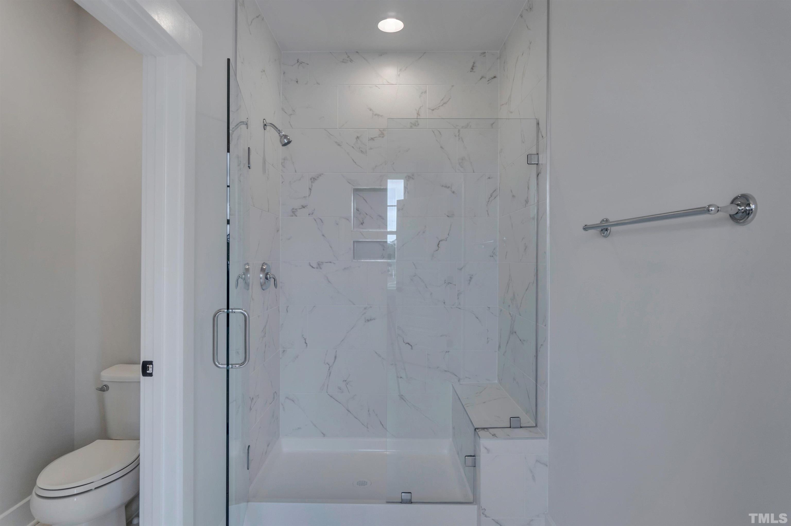 167 Dunloe Loop Raleigh, NC 27603 - Photo 10 of 16 a bathroom with a shower and toilet
