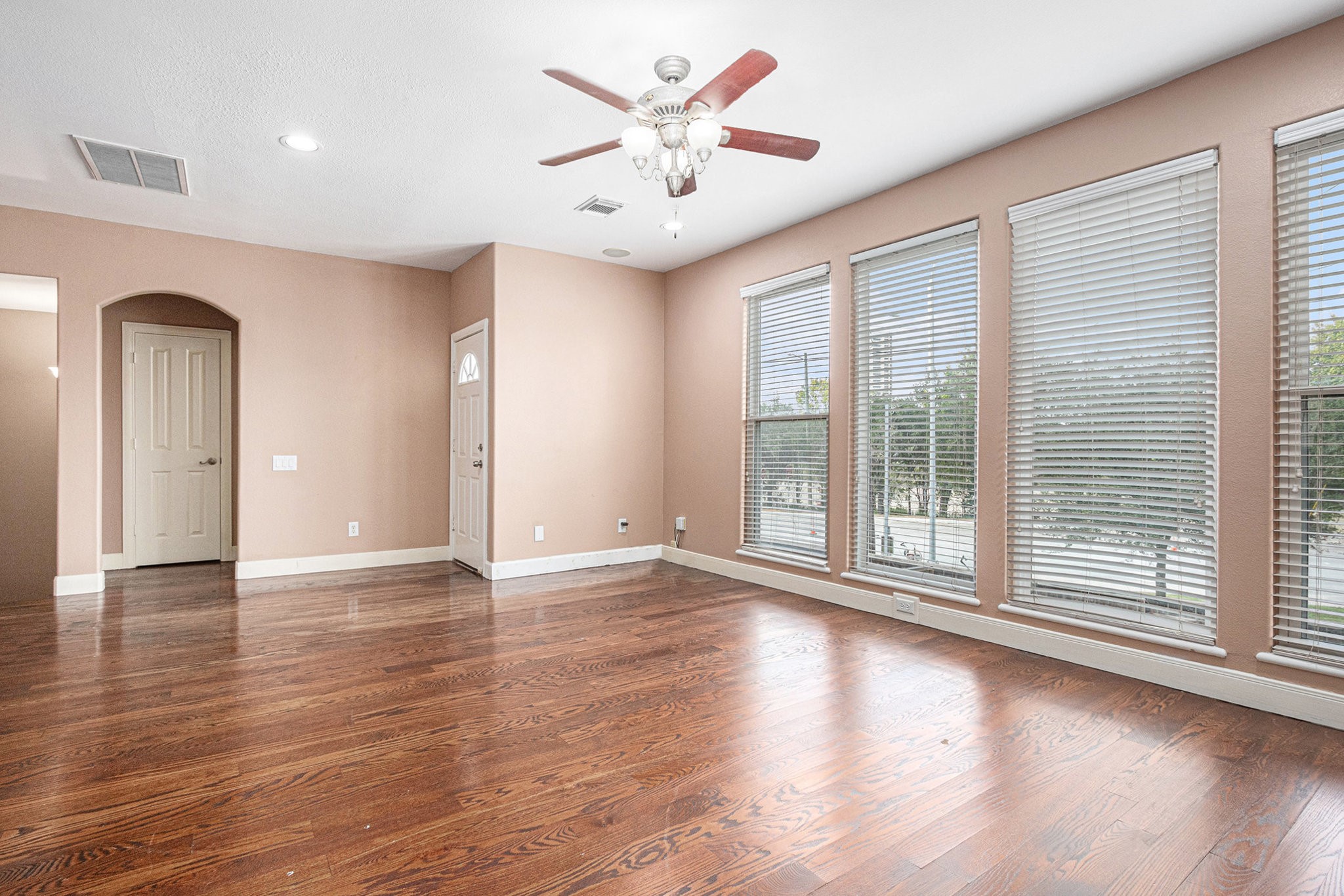 2402 Calumet Street, Unit B Houston, TX 77004 - Photo 8 of 40 a view of an empty room with a window and wooden floor
