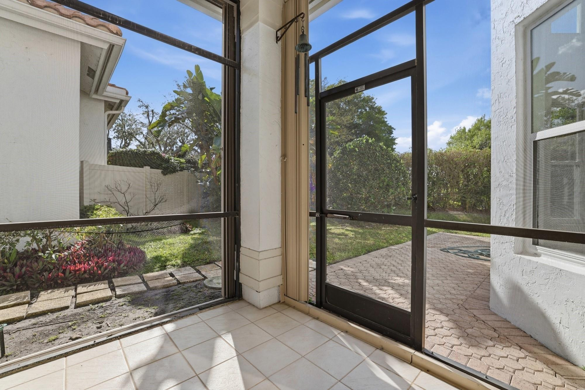 2498 Northwest 63rd Street Boca Raton, FL 33496 - Photo 12 of 39 a view of a room with wooden floor and floor to ceiling window
