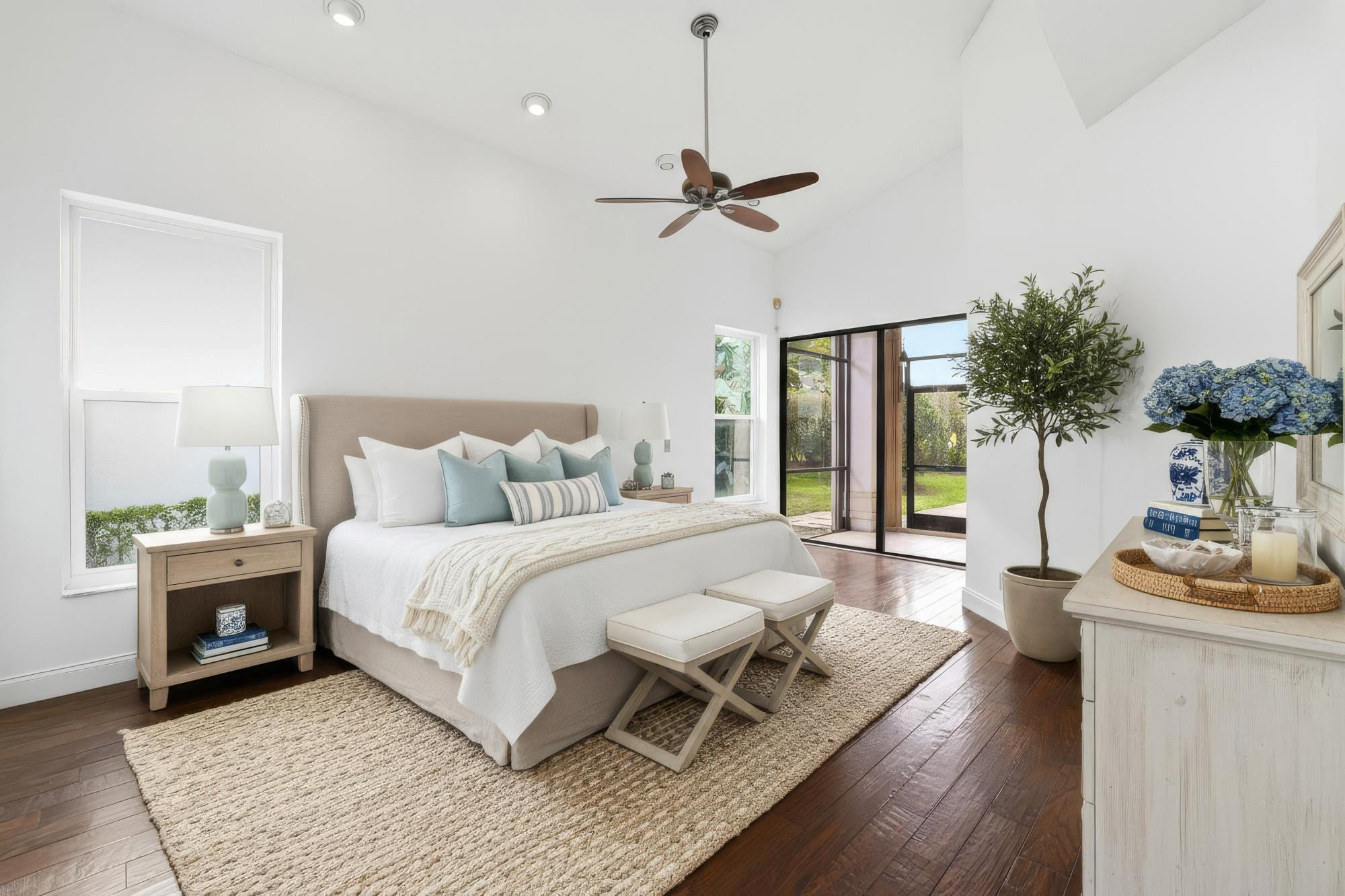 2498 Northwest 63rd Street Boca Raton, FL 33496 - Photo 14 of 39 a spacious bedroom with a bed couch and a potted plant