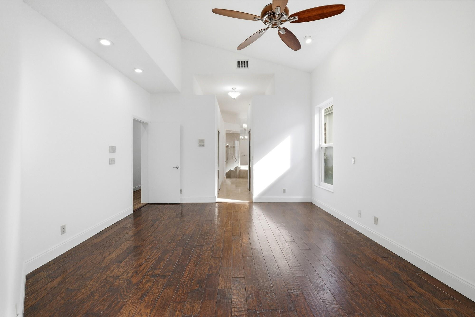 2498 Northwest 63rd Street Boca Raton, FL 33496 - Photo 15 of 39 a view of an empty room with wooden floor and window