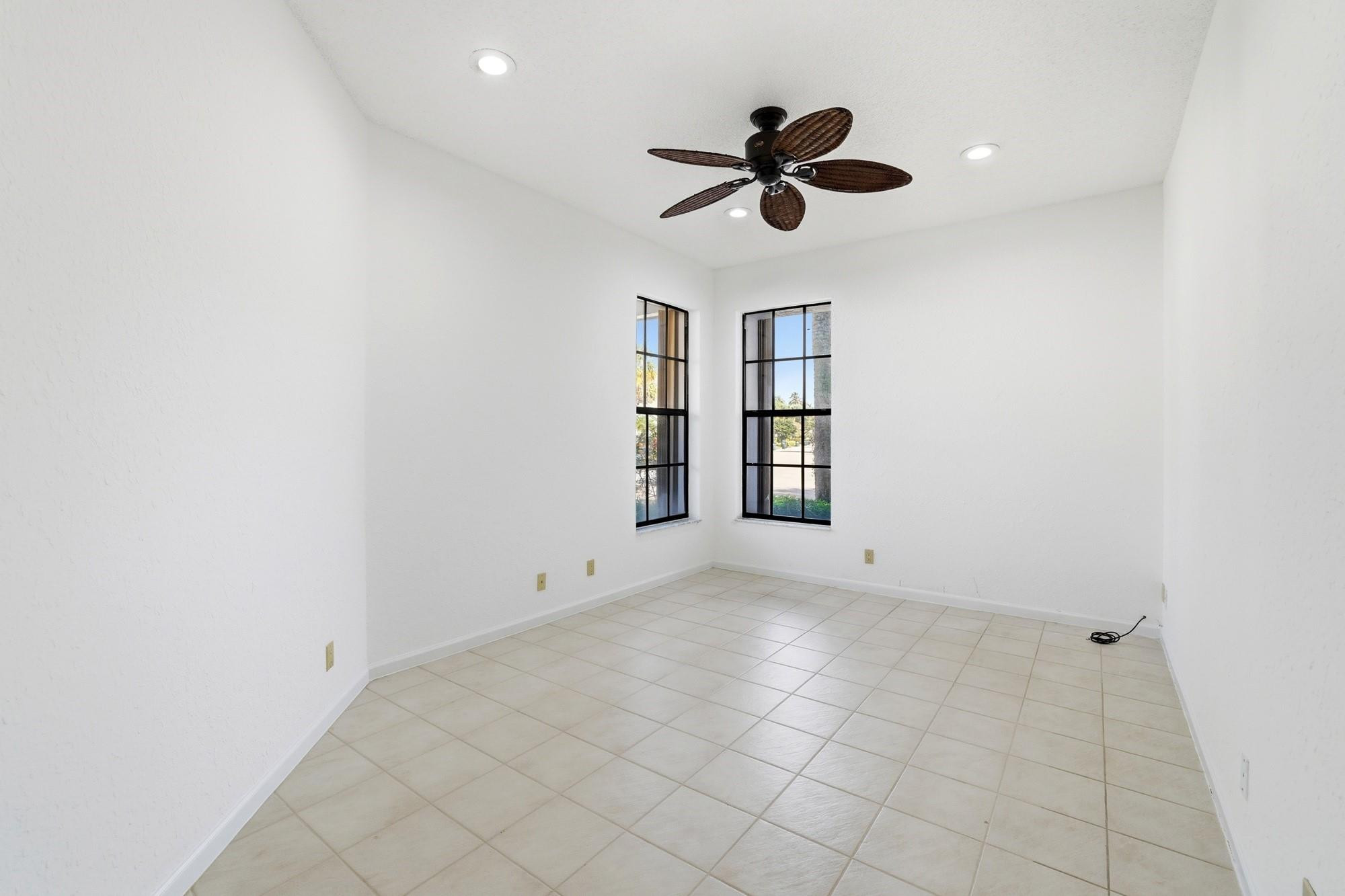2498 Northwest 63rd Street Boca Raton, FL 33496 - Photo 19 of 39 an empty room with windows and fan