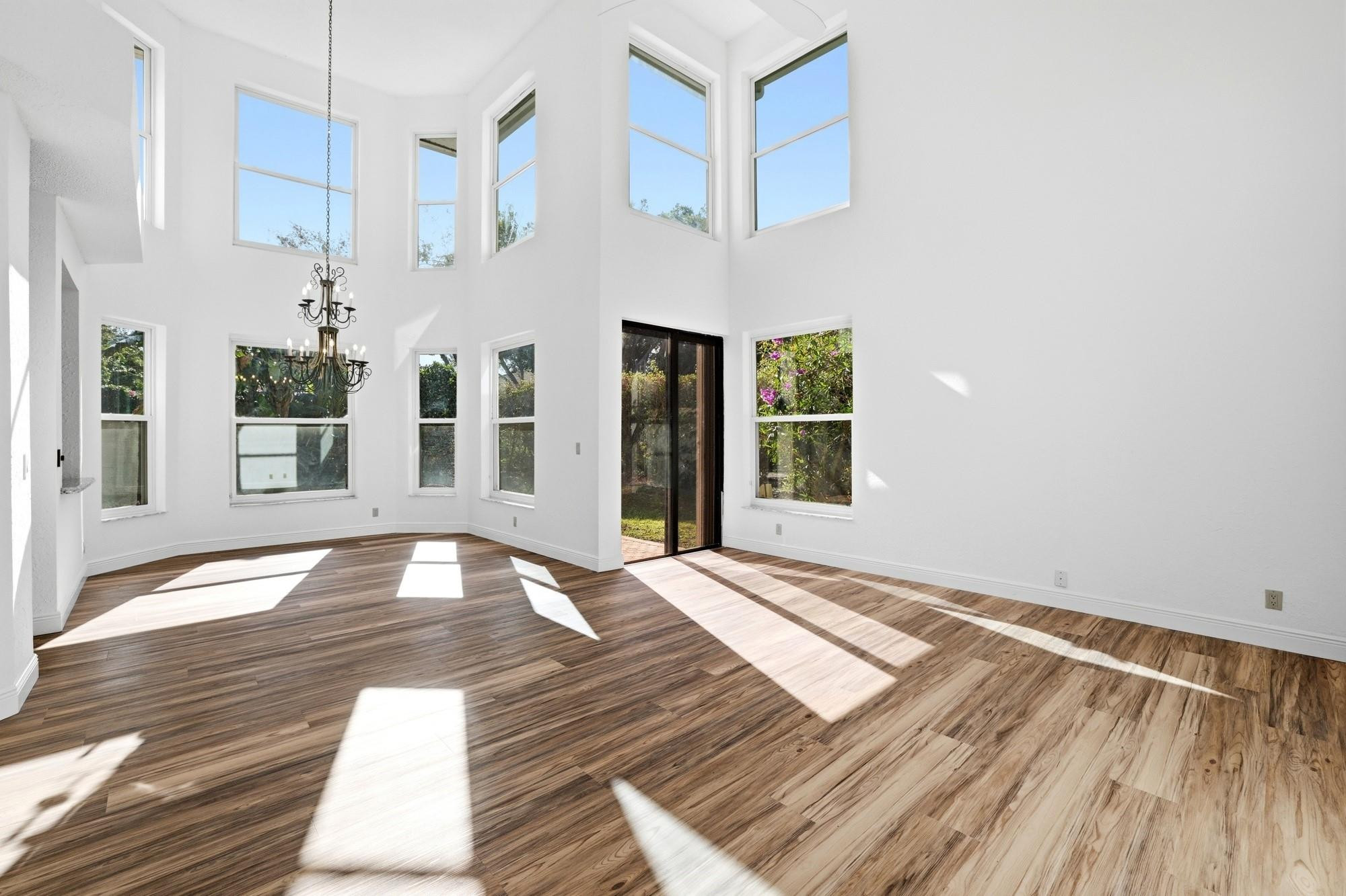 2498 Northwest 63rd Street Boca Raton, FL 33496 - Photo 2 of 39 a view of an empty room with wooden floor and a window