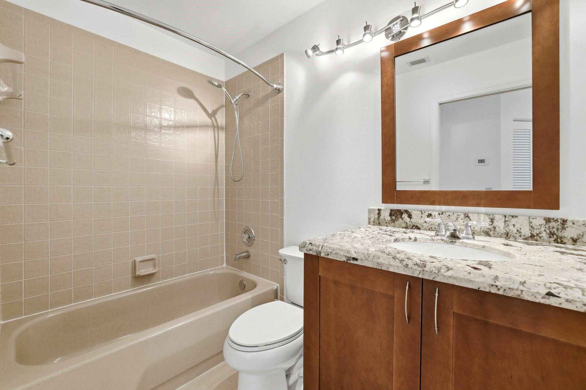 2498 Northwest 63rd Street Boca Raton, FL 33496 - Photo 23 of 39 a bathroom with a sink and a mirror