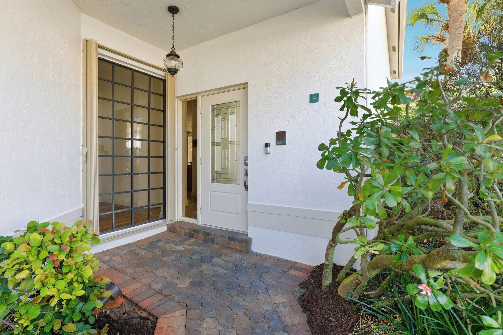 2498 Northwest 63rd Street Boca Raton, FL 33496 - Photo 28 of 39 a view of entryway with flower plants