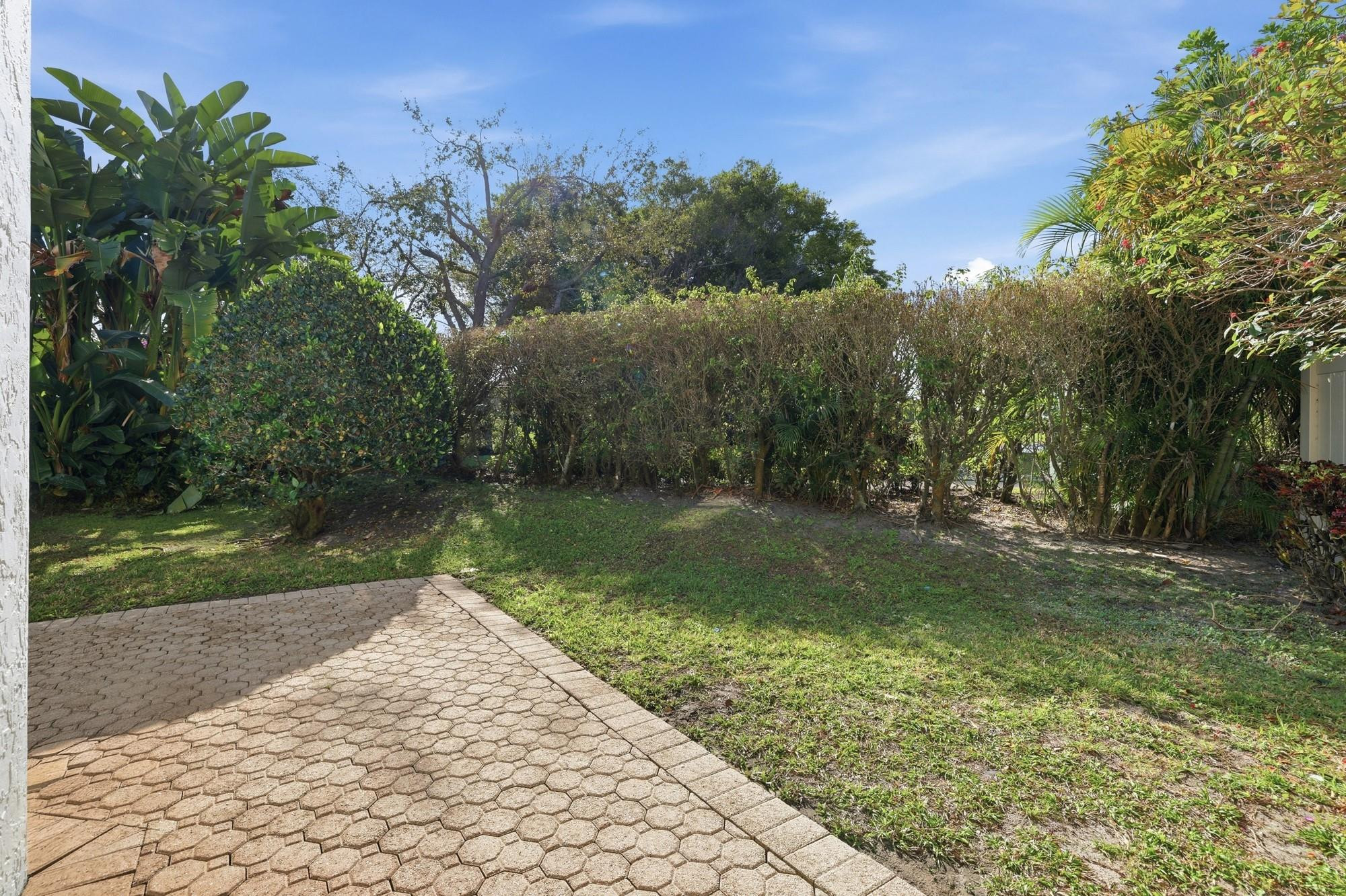 2498 Northwest 63rd Street Boca Raton, FL 33496 - Photo 29 of 39 a view of a pathway with a yard