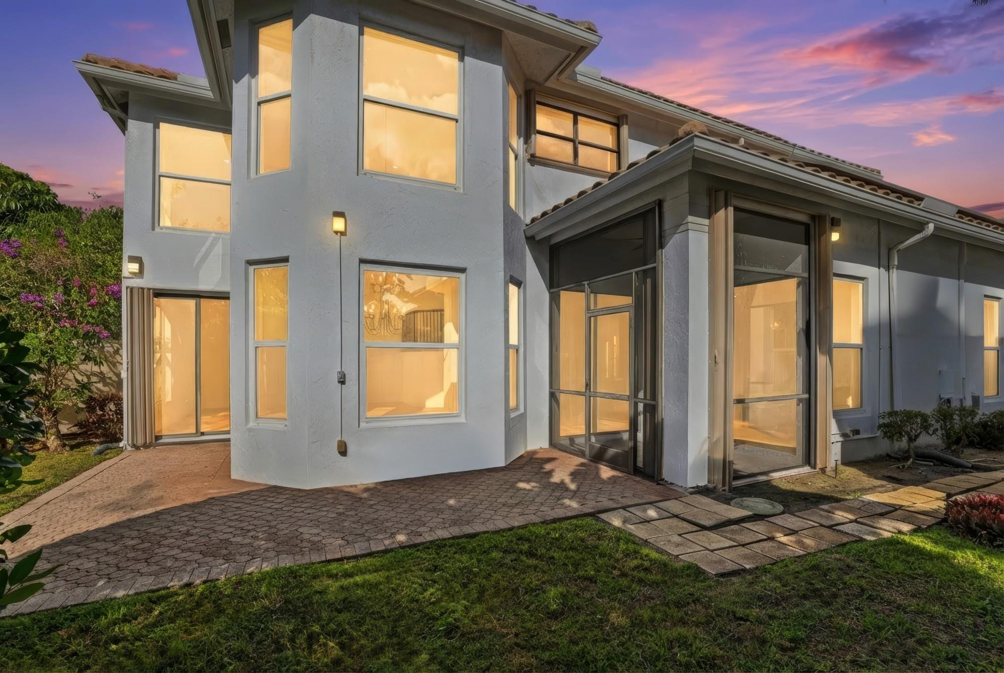 2498 Northwest 63rd Street Boca Raton, FL 33496 - Photo 30 of 39 a front view of a house with a yard