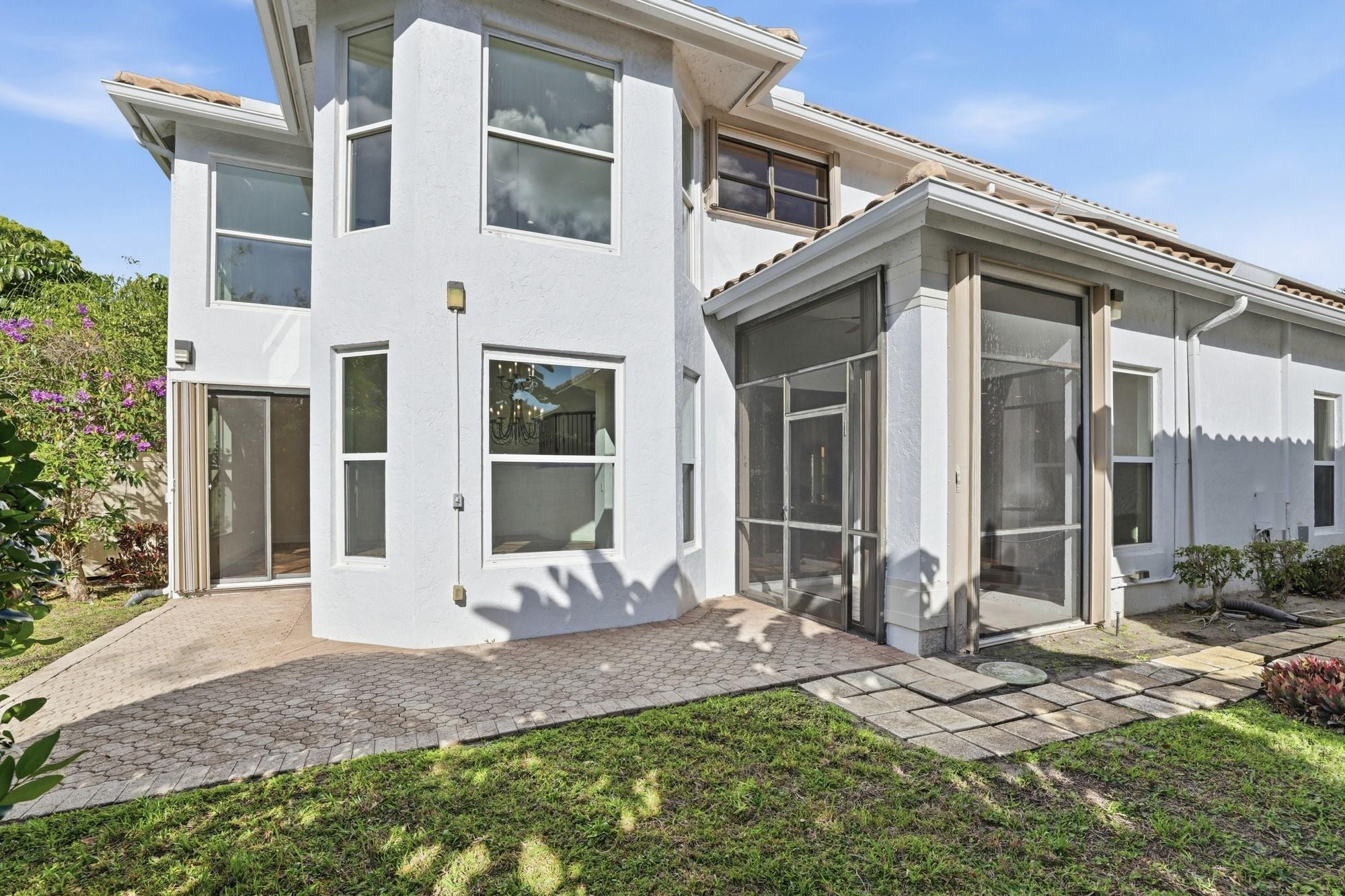 2498 Northwest 63rd Street Boca Raton, FL 33496 - Photo 31 of 39 a front view of a house with a yard