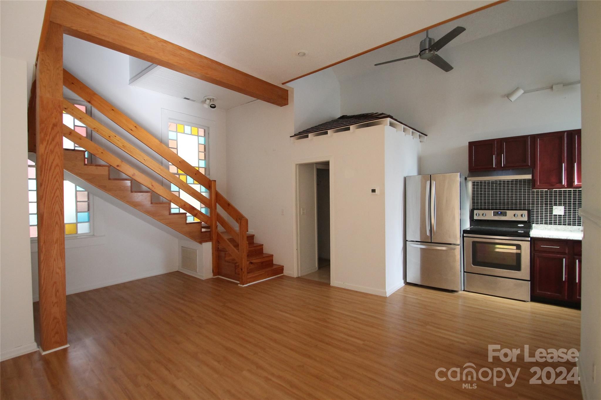 112 Steele Street, Unit 4 Fort Mill, SC 29715 - Photo 2 of 10 a view of a kitchen with a stove refrigerator and wooden floor