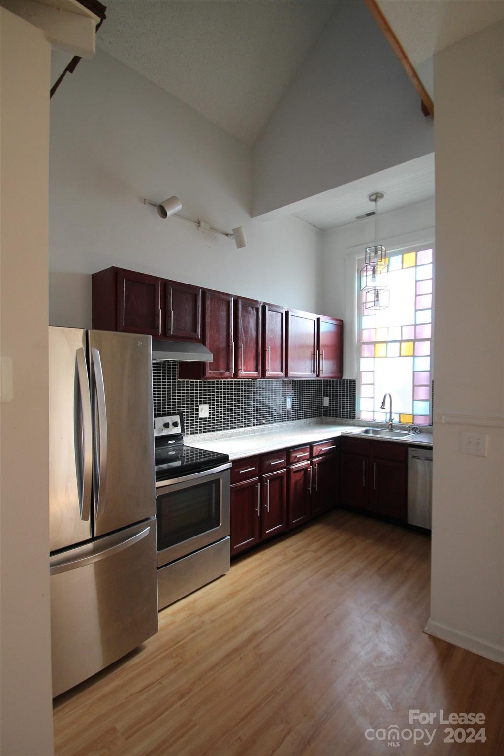 112 Steele Street, Unit 4 Fort Mill, SC 29715 - Photo 4 of 10 a kitchen with stainless steel appliances granite countertop a refrigerator a sink dishwasher a stove and white countertops with wooden floor