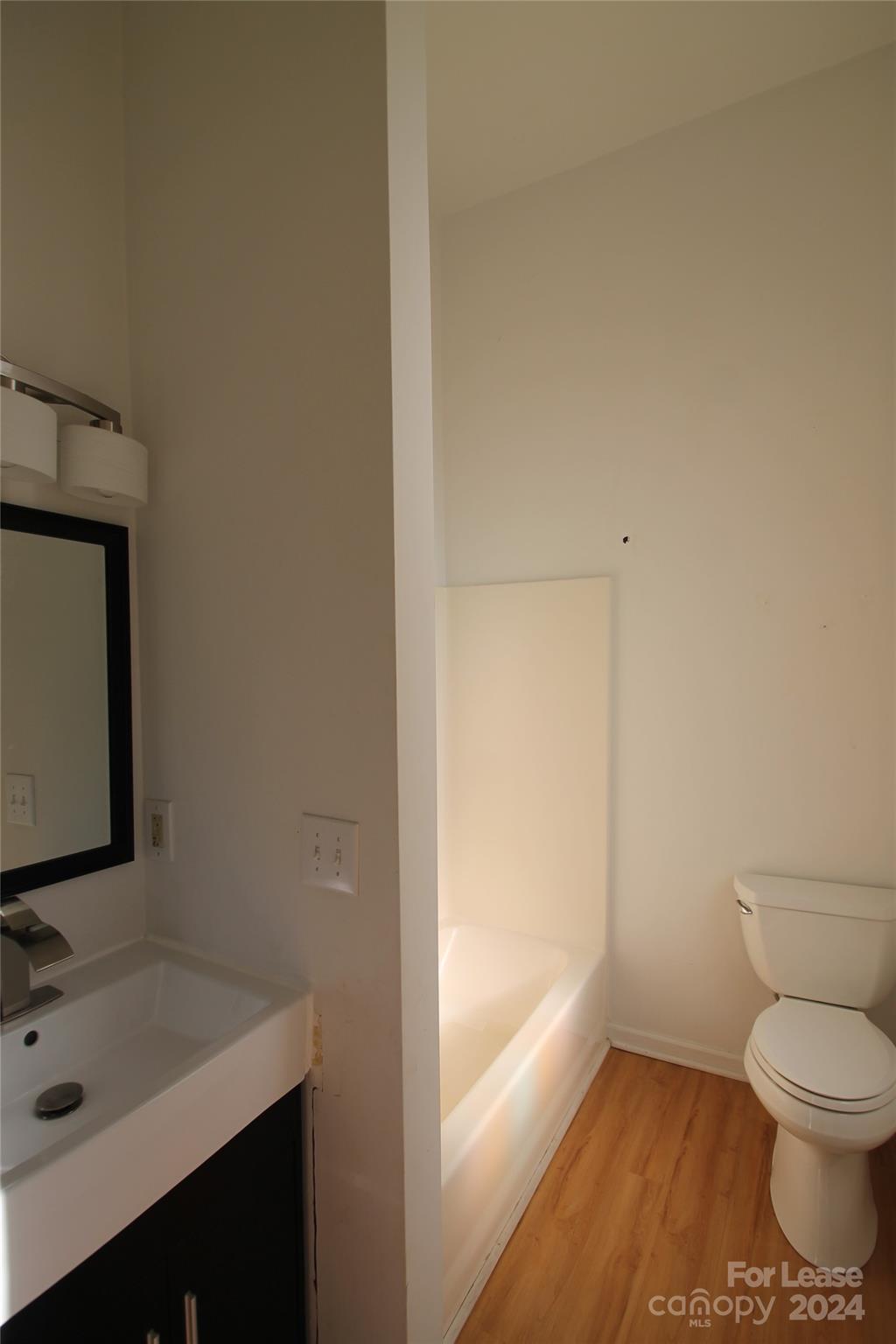 112 Steele Street, Unit 4 Fort Mill, SC 29715 - Photo 5 of 10 a bathroom with a sink toilet and vanity