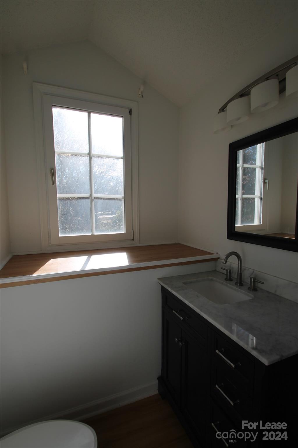 112 Steele Street, Unit 4 Fort Mill, SC 29715 - Photo 8 of 10 a bathroom with a sink a vanity and a window