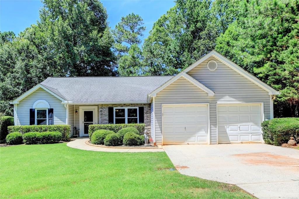 4025 Ridgebrook Bend Cumming, GA 30028 - Photo 1 of 1 a front view of a house with a yard and garage