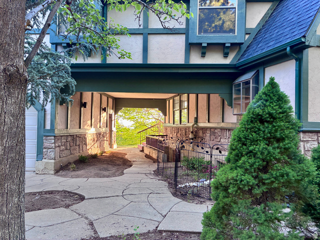 1903 Ridgehollow Drive Bountiful, UT 84010 - Photo 20 of 24 Tudor-style exterior showcasing a prominent stone foundation, half-timber detailing, and a blue shingle roof