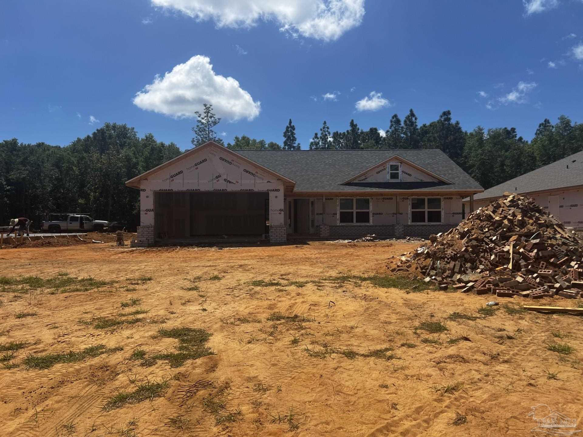 5267 Muscadine Way Milton, FL 32570 - Photo 2 of 2 a front view of a house with a yard