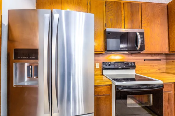 a kitchen with a refrigerator and a stove