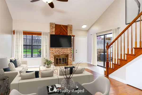a living room with fireplace furniture and a flat screen tv