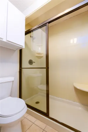a bathroom with a shower and a toilet