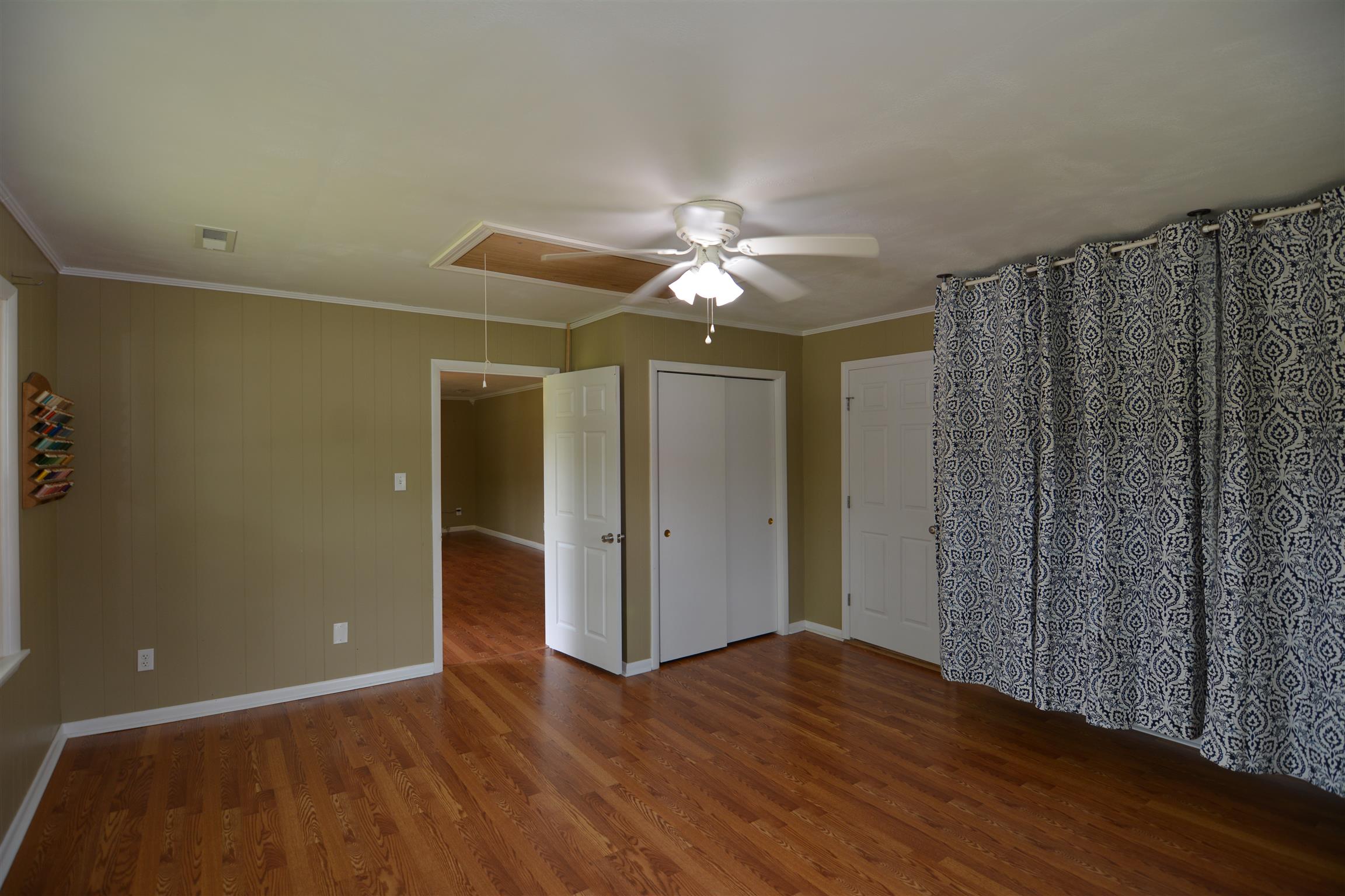 136 McBurg Road Frankewing, TN 38459 - Photo 6 of 20 The master bedroom leads back out toward the kitchen and dining room.