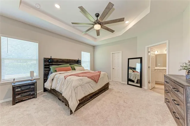 a bathroom with double vanity sink a mirror and a shower