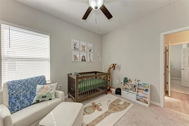 a bedroom with a bed and painting on the wall