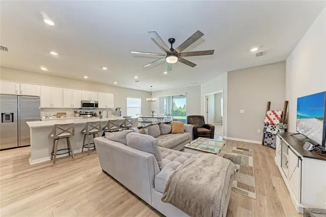 a living room with furniture ceiling fan and a rug