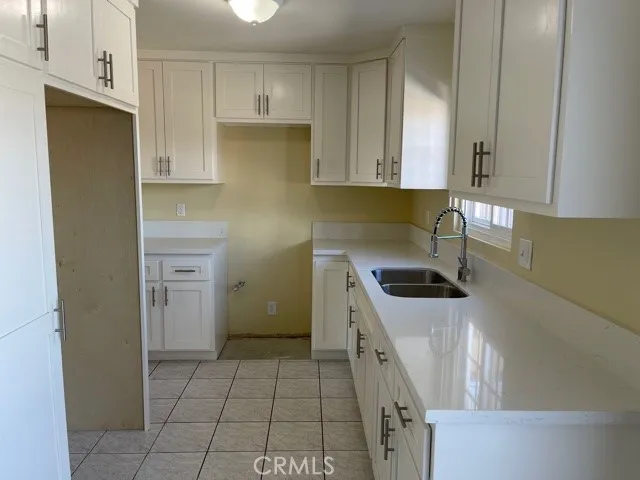a kitchen with a sink a stove and refrigerator