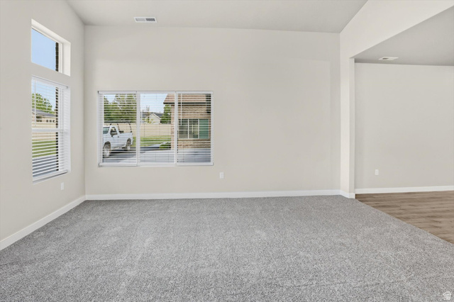 1838 West 300th Street South, Unit B Mapleton, UT 84664 - Photo 7 of 51 Spacious interior featuring high ceilings, light-toned walls, and grey carpeting