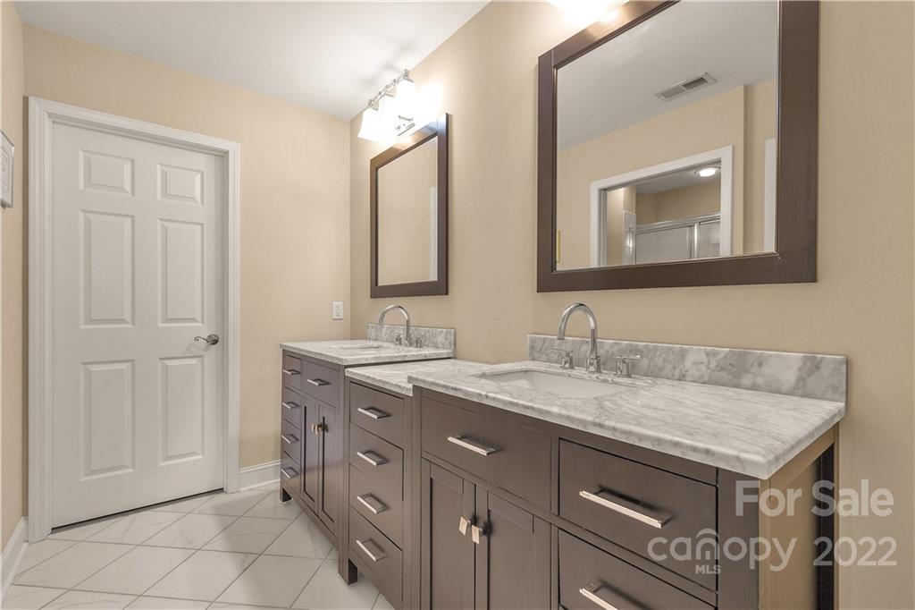 705 Ledgestone Court Tega Cay, SC 29708 - Photo 17 of 24 a bathroom with a granite countertop sink and a mirror