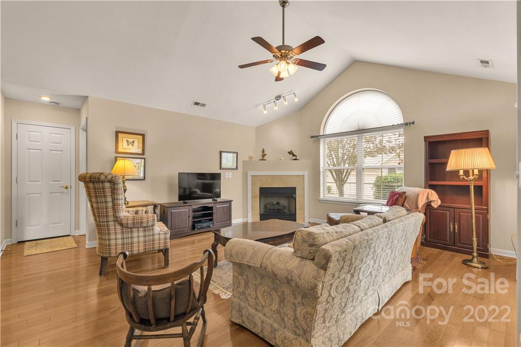 705 Ledgestone Court Tega Cay, SC 29708 - Photo 8 of 24 a living room with furniture a fireplace and a flat screen tv