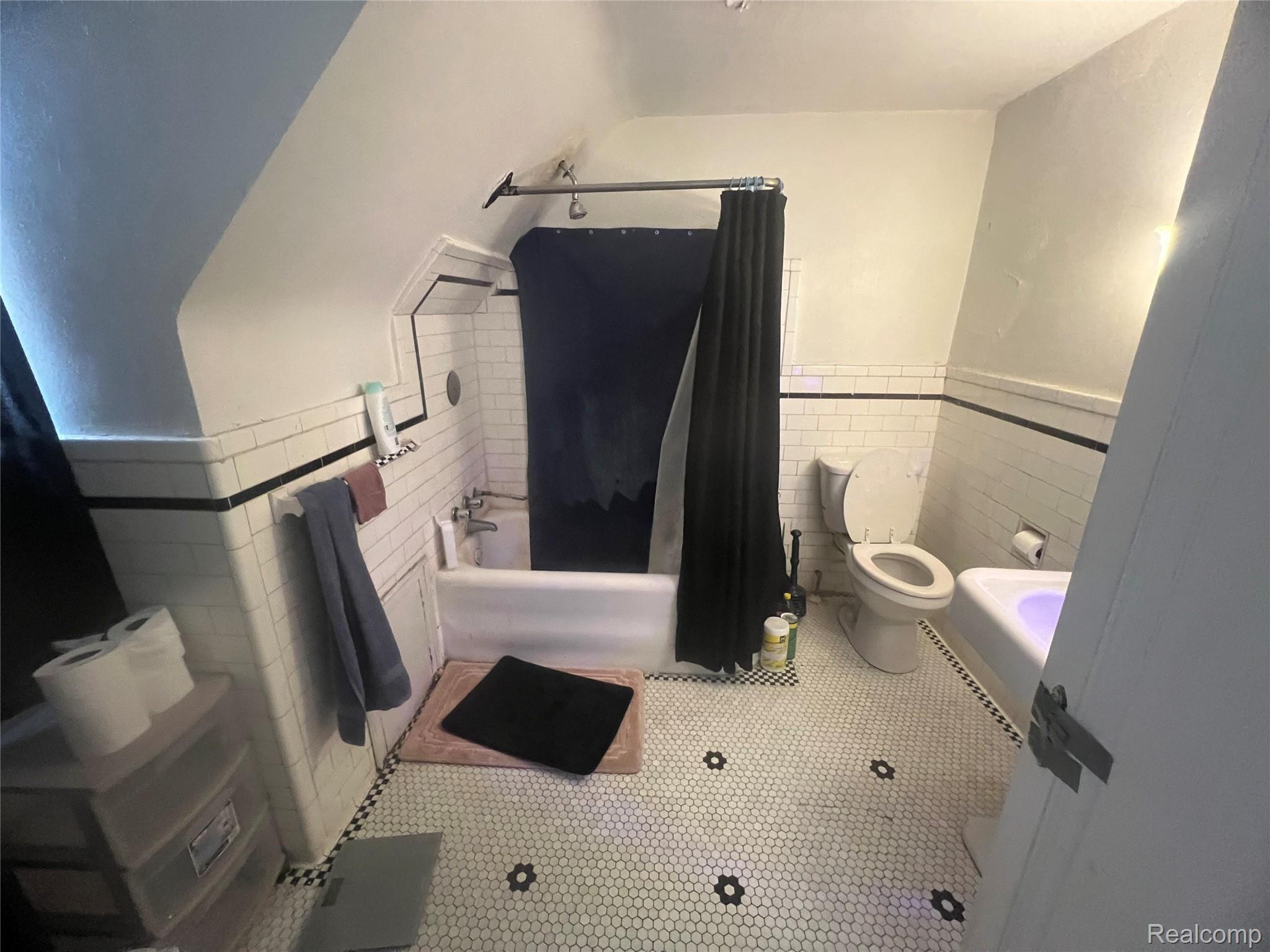 17311 Santa Rosa Drive Detroit, MI 48221 - Photo 86 of 89 White hex tile flooring with black flower accents