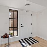 a view of a livingroom with wooden floor and a carpet
