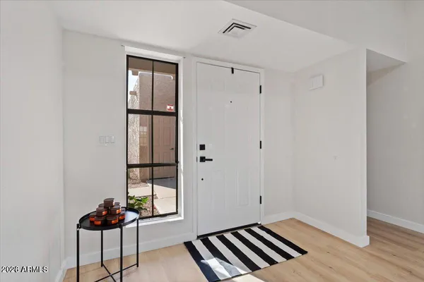a view of a livingroom with wooden floor and a carpet