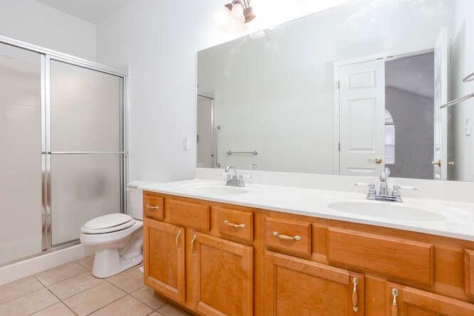 3402 Raes Creek Road, Unit 27 Marietta, GA 30008 - Photo 20 of 32 a bathroom with a granite countertop sink toilet and a mirror