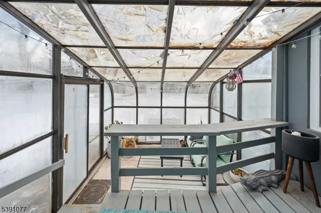 a view of a chairs and table in the balcony