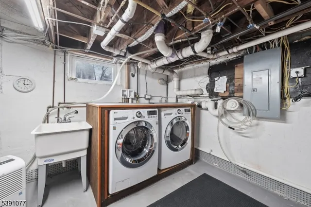 a utility room with dryer washer and stair