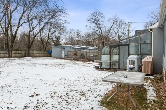 a view of a backyard with snow on the road