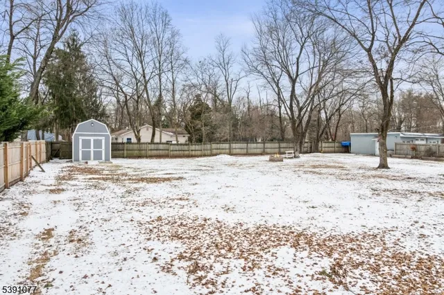 a view of white house with snow on the road