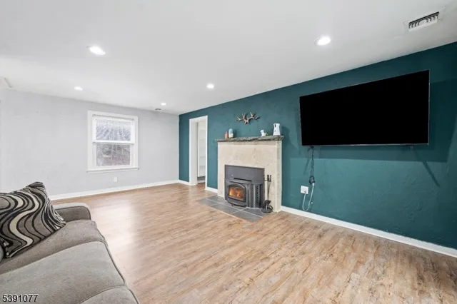 a view of livingroom with furniture fireplace and a window