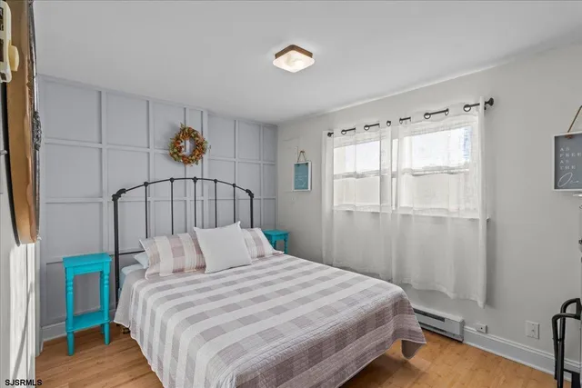 a bedroom with furniture and a wooden floor