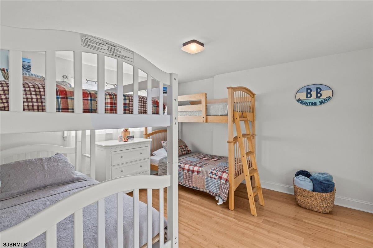1000 West Brigantine Avenue, Unit 4 Brigantine, NJ 08203 - Photo 18 of 35 a bedroom with furniture and a wooden floor