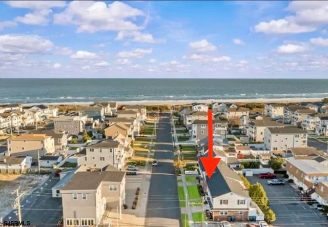 a kitchen with stainless steel appliances a stove a sink and white cabinets