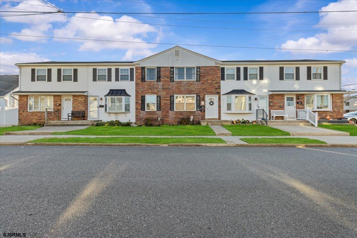 1000 West Brigantine Avenue, Unit 4 Brigantine, NJ 08203 - Photo 33 of 35 a front view of residential houses with yard and green space
